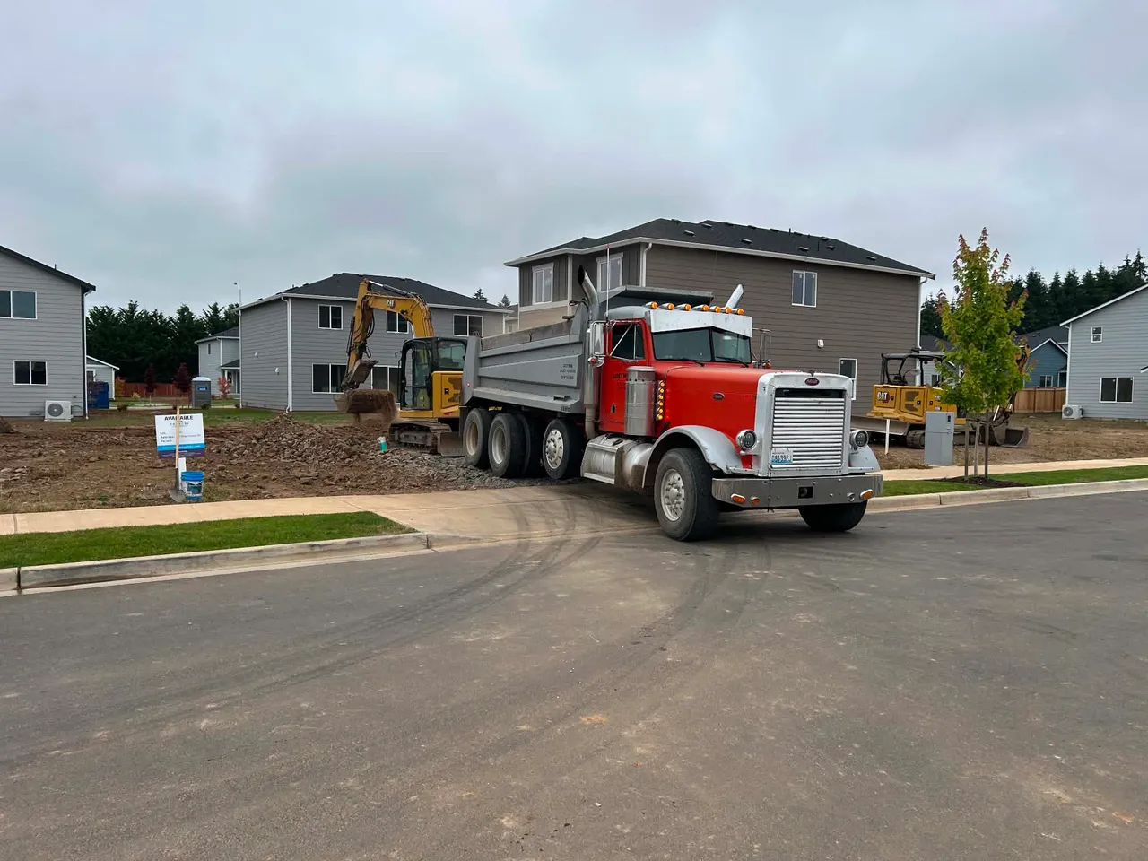The Gritworks dump truck making a delivery on a residential street.