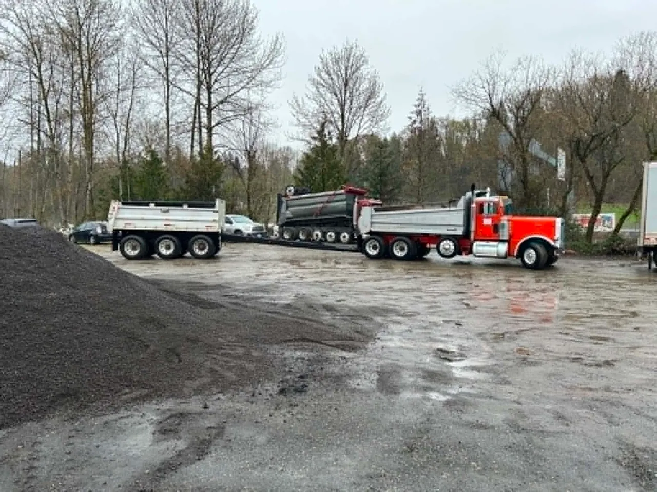 Gritworks Trucking's 1990 Peterbilt 379 with its pup trailer, loaded at a materials yard.